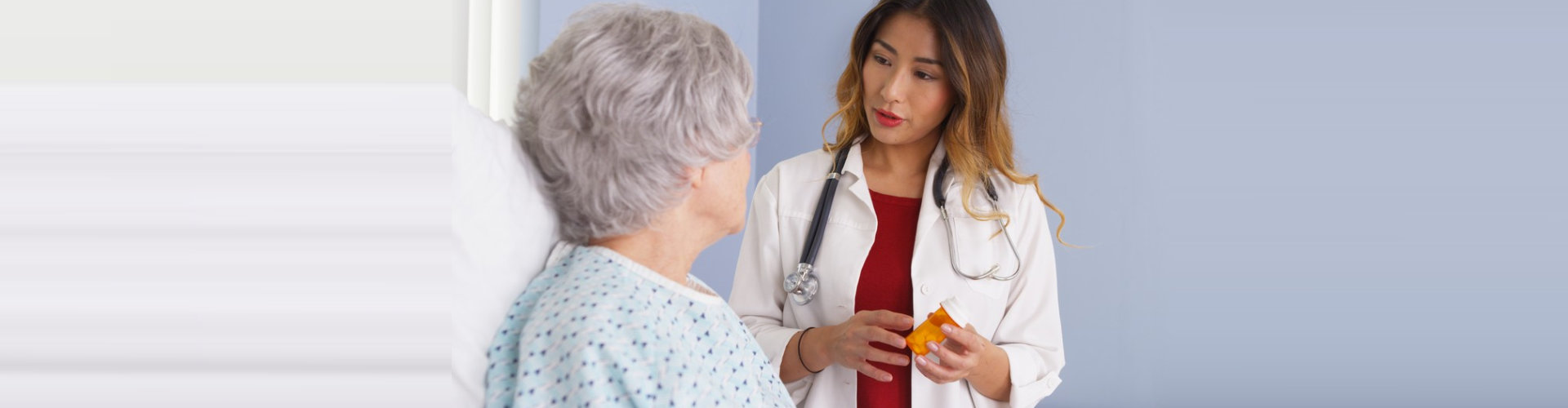 pharmacist showing elder woman medicinal options